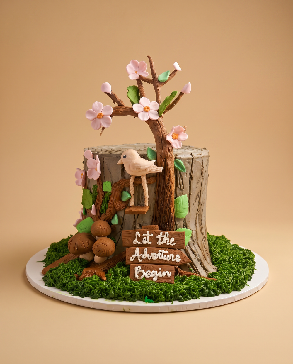 Tree stump fondant cake with cherry blossom branch, perched bird, mushrooms, and a 